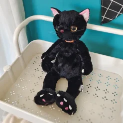 Peluche chat noir mécontent assis
